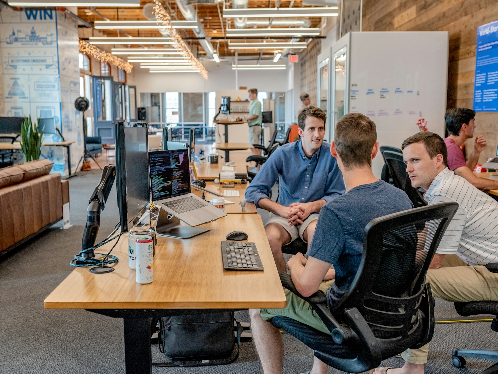 Team working together around laptops in an office